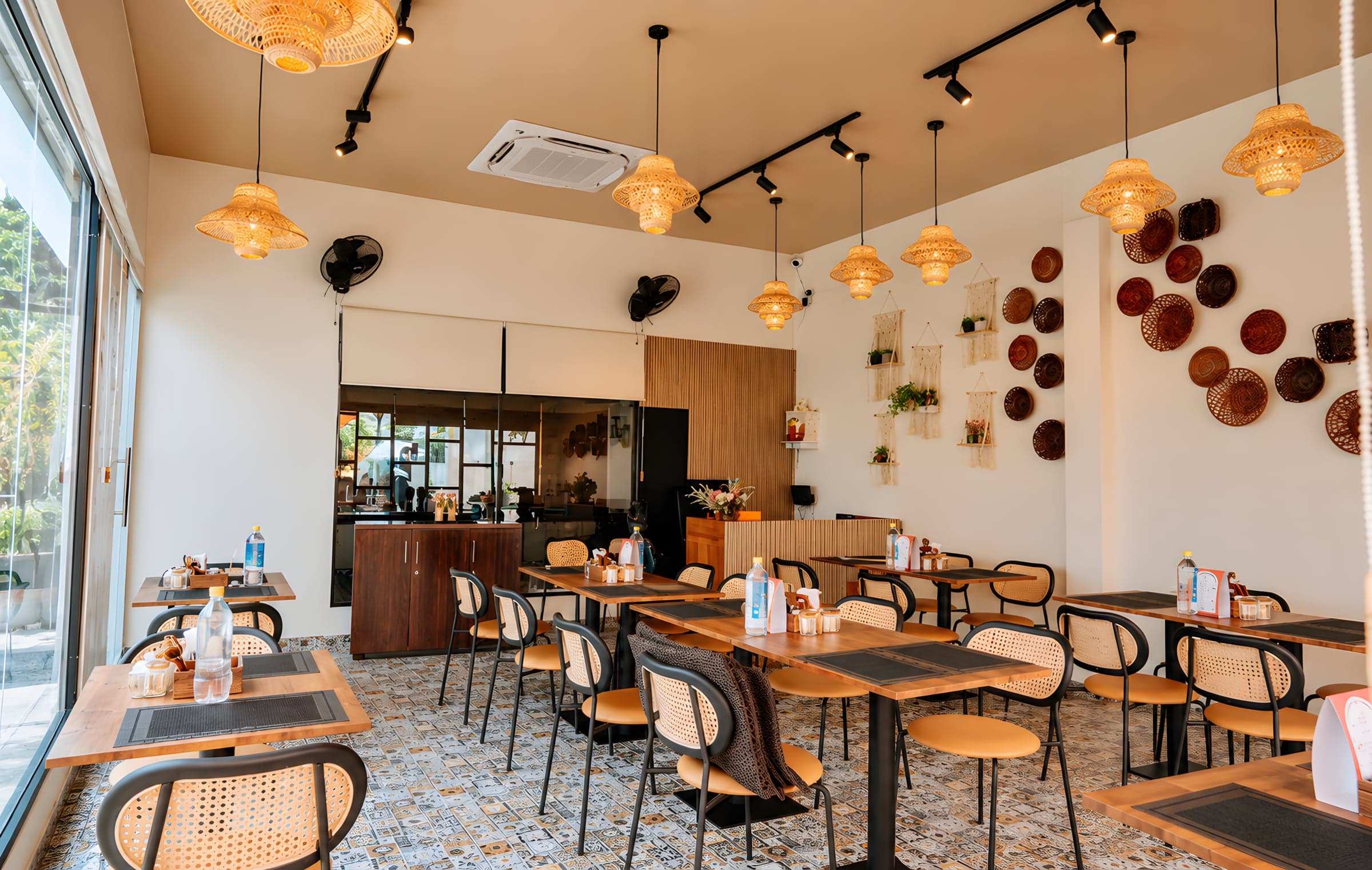 Inside Pawpup: wooden tables, rattan chairs and woven lamps leading to the counter